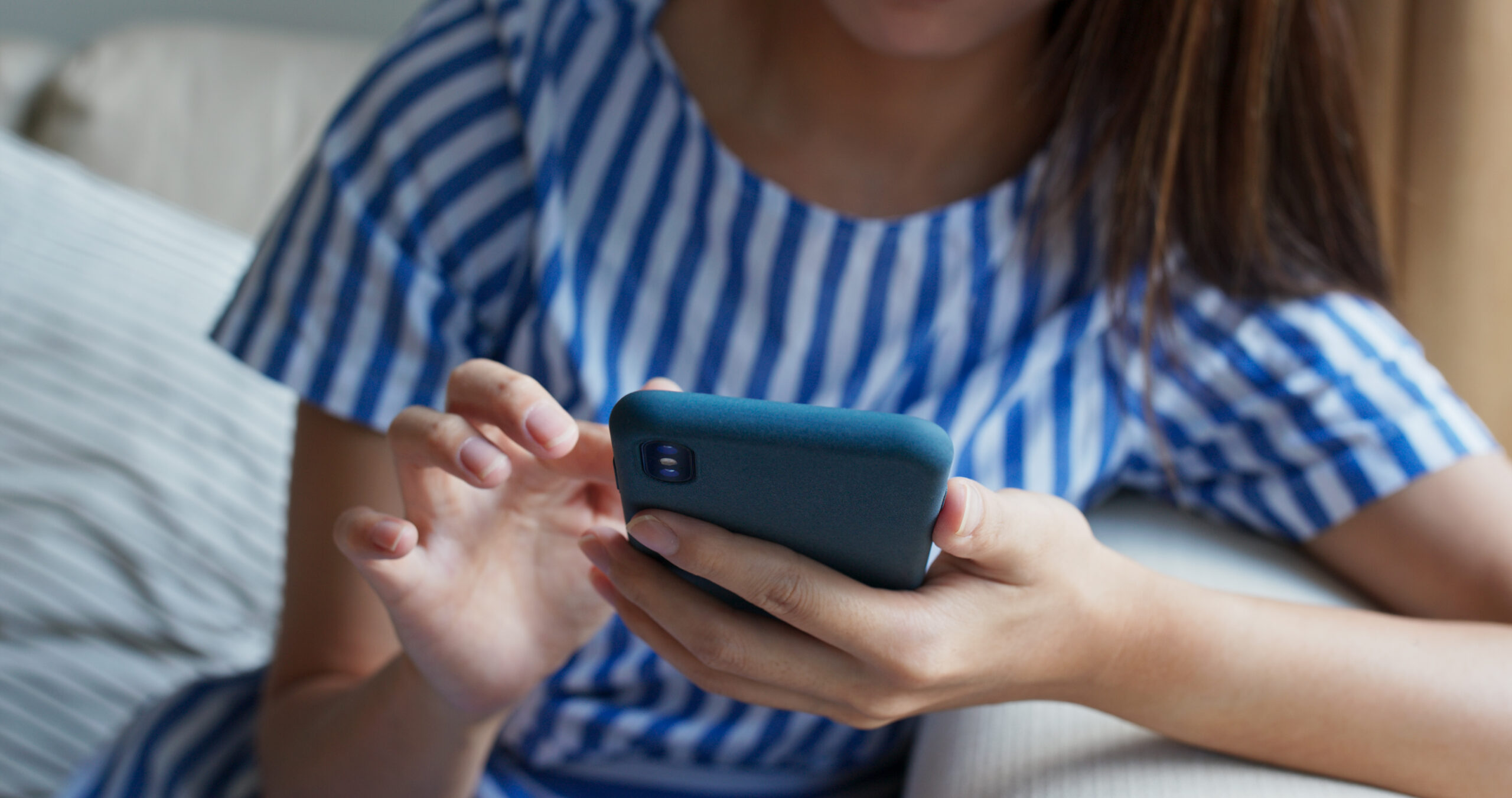 Close up of woman use of mobile phone at home
